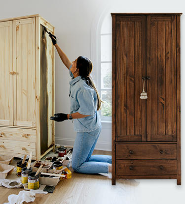 Person staining a wood cabinet